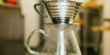 Barista preparing coffee with filter