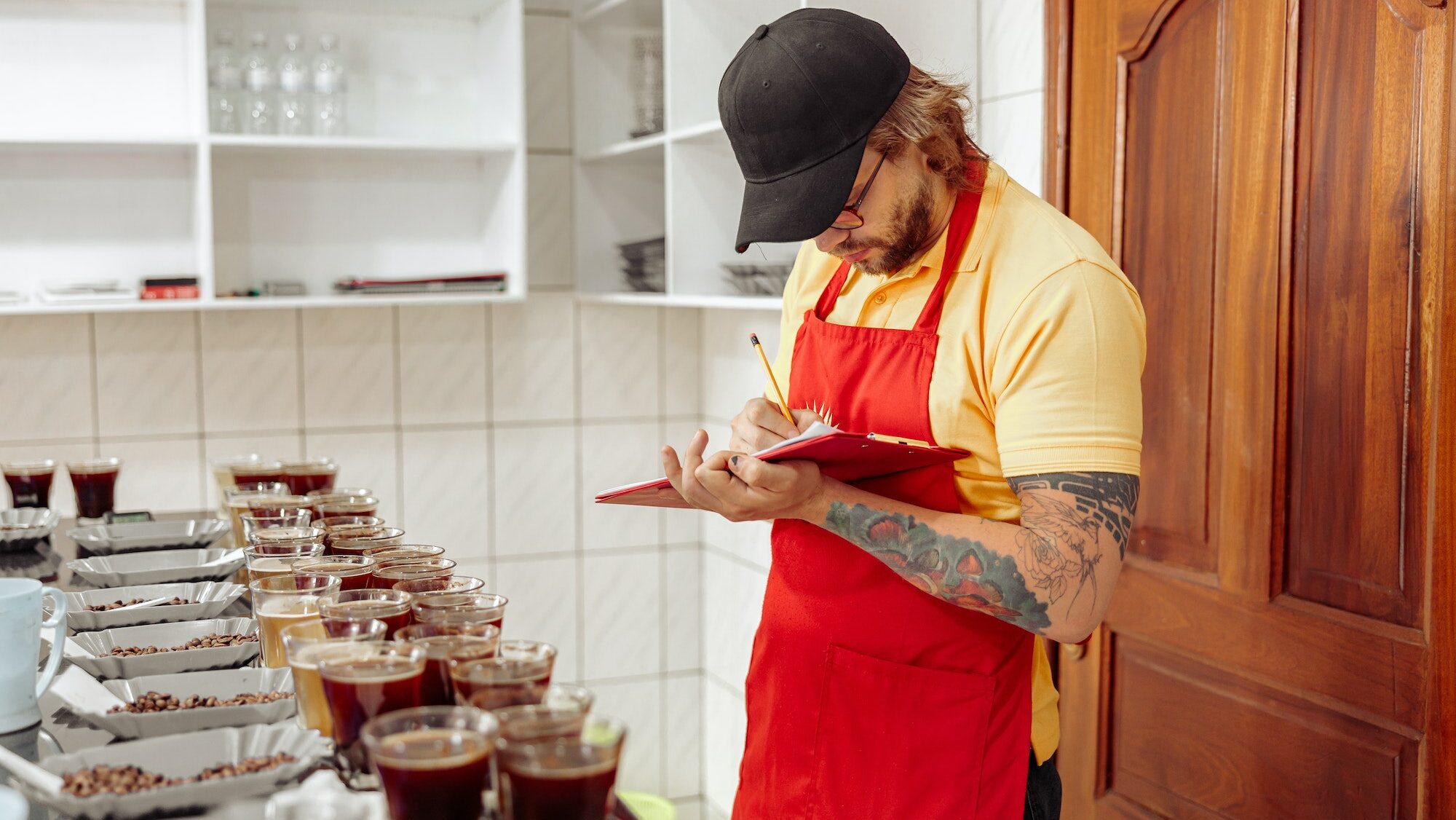 Male worker taking notes before coffee tasting