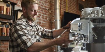Man preparing espresso in a cafe