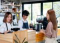 Asian barista or coffee maker receive the order from customer woman