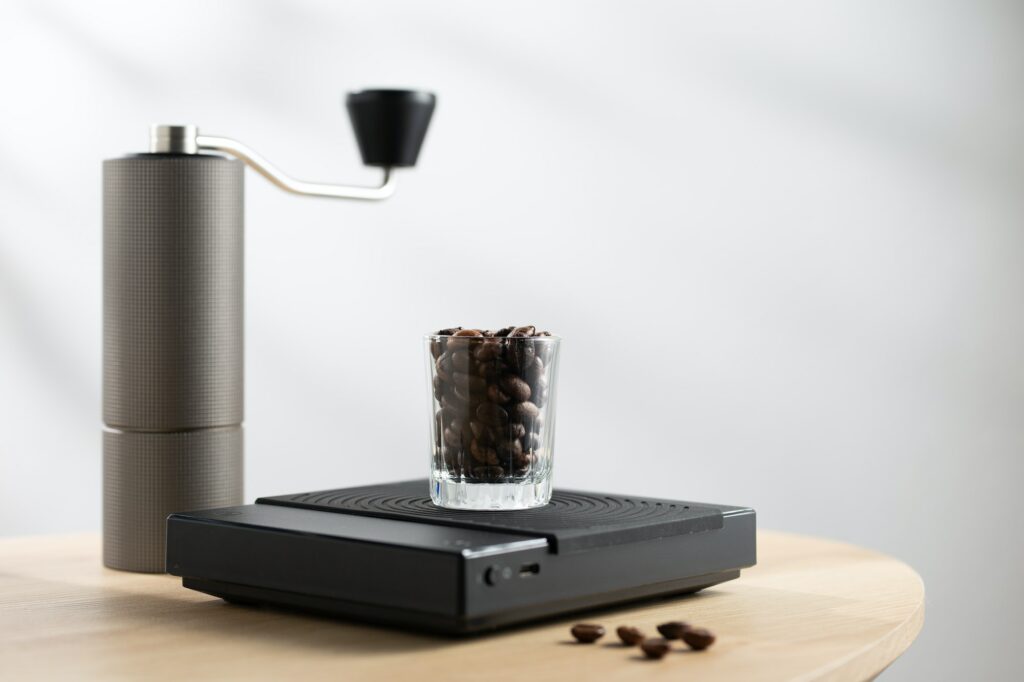 Coffee beans in a clear glass on a digital scale