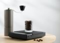 Coffee beans in a clear glass on a digital scale