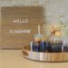 Cold brew iced coffee on a wooden tray and hello sunshine on a wooden message board