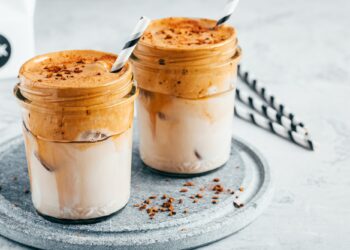 Dalgona coffee. Iced coffee with creamy whipped foam and almond milk.