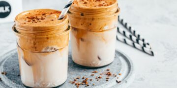 Dalgona coffee. Iced coffee with creamy whipped foam and almond milk.