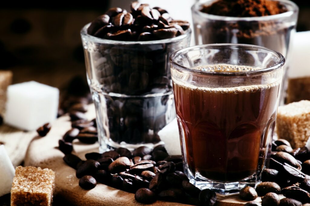 Grinded Arabica coffee beans, freshly brewed espresso