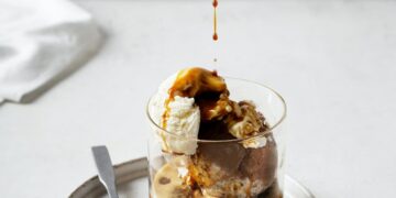 Ice cream with coffee espresso in glass on white or grey background