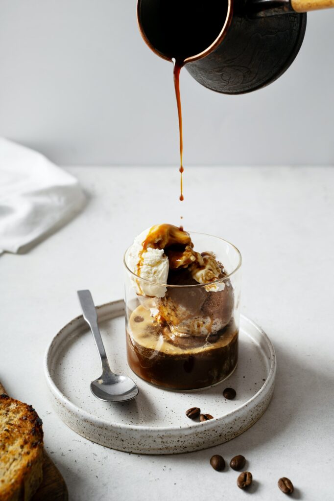 Ice cream with coffee espresso in glass on white or grey background