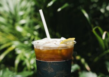 Iced cold brew coffee with lemon on a table