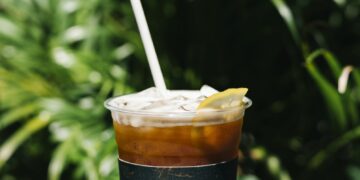 Iced cold brew coffee with lemon on a table