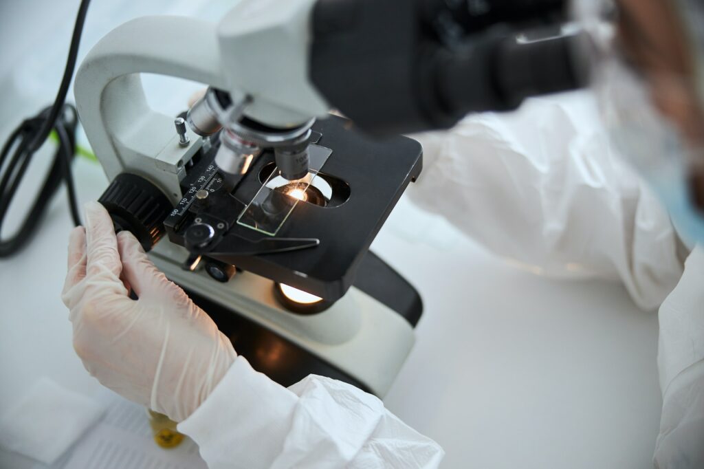 Microbiologist observing a microscopic specimen under the microscope