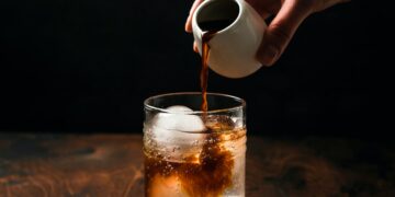 Preparing espresso tonic with orange juice