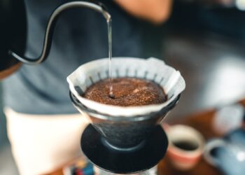 Professional barista preparing coffee pour over coffee maker and drip kettle
