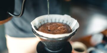 Professional barista preparing coffee pour over coffee maker and drip kettle