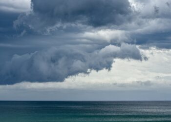 Storm clouds rolling in over the South Pacific and Pebbly Beach at the Murramarang National Park.