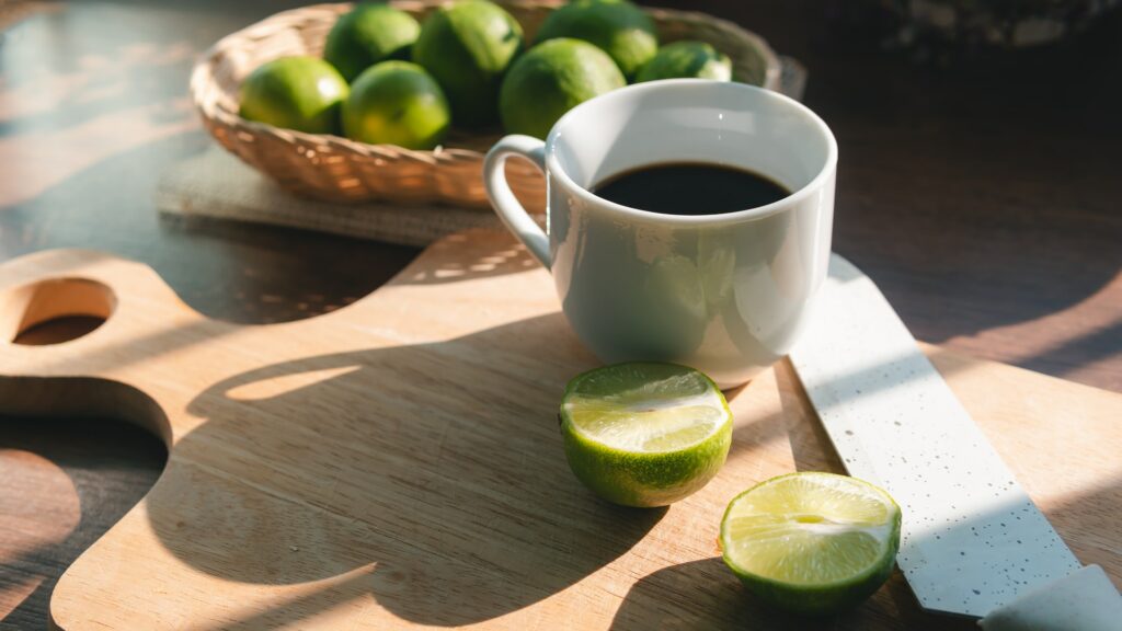 A cup of coffee with lemon no sugar, concept of healthy drink and detox colon or diet food.
