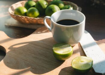 A cup of coffee with lemon no sugar, concept of healthy drink and detox colon or diet food.
