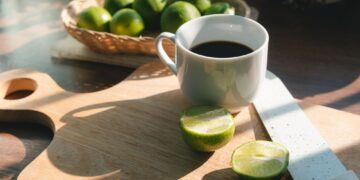 A cup of coffee with lemon no sugar, concept of healthy drink and detox colon or diet food.