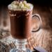 Chocolate coffee with whipped cream on wooden background