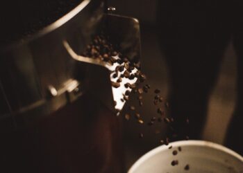 Coffee beans flowing from coffee roaster
