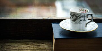Coffee cup with old book