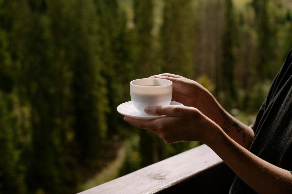 coffee on the balcony with forest view, white cup close up, background, morning rituals, relaxing