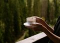 coffee on the balcony with forest view, white cup close up, background, morning rituals, relaxing