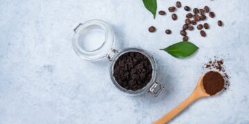 Concept with natural ingredients for home body coffee scrub with coffee beans and coffee powder