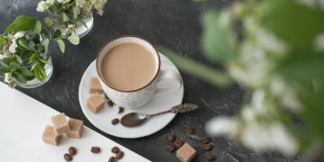 flat white coffee in a cup. brown sugar and coffee beans