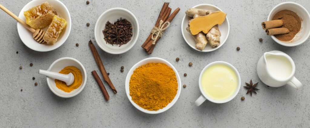 Golden milk with cinnamon, honey, curcuma root and turmeric powder