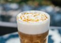 Hot latte macchiato coffee with caramel outdoor