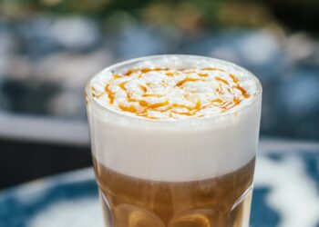 Hot latte macchiato coffee with caramel outdoor