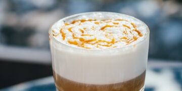 Hot latte macchiato coffee with caramel outdoor