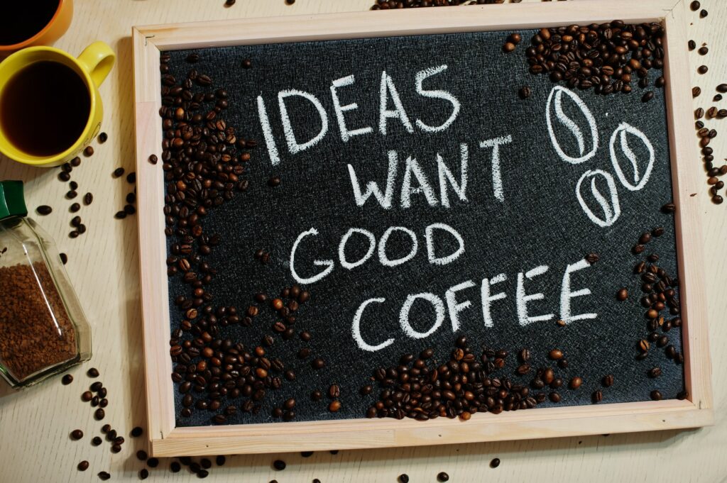 Ideas want good coffee. Words on blackboard flat lay.