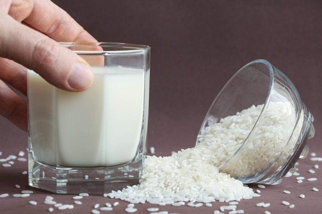 Person holds glass with rice milk