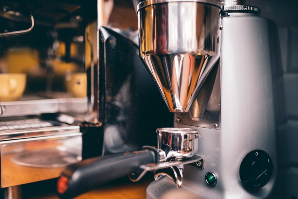 Professional coffee milling machinery preparing for espresso making