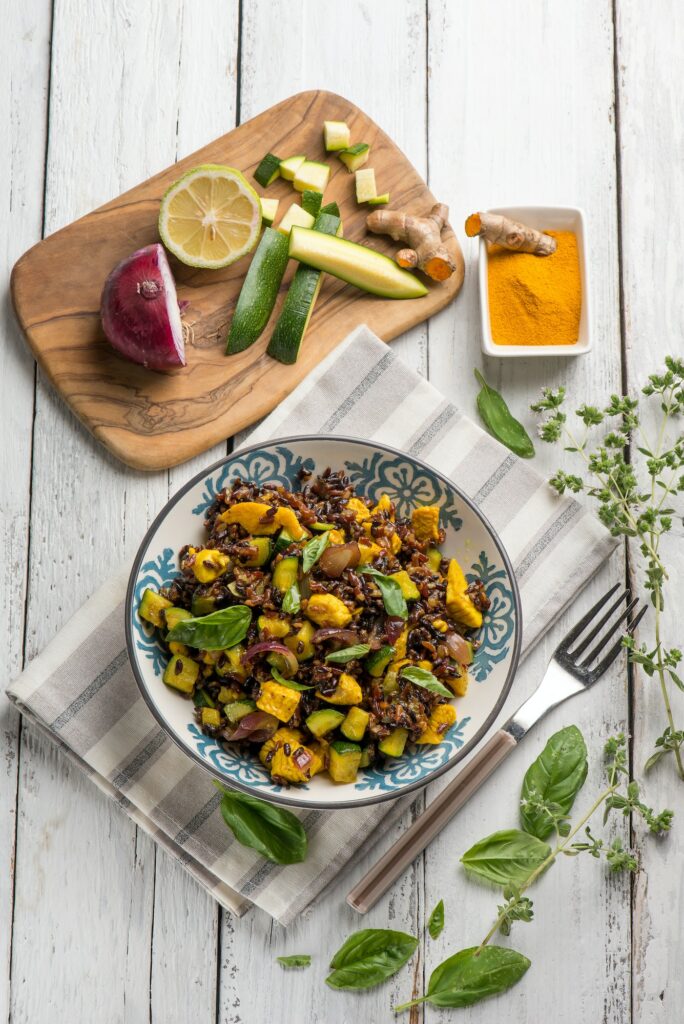 red rice salad with chicken zucchinis and tumeric