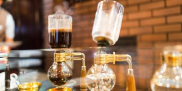 Siphon vacuum coffee maker on cafe bar