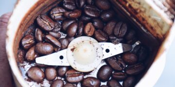 Closeup of coffee beans in a coffee grinder