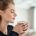 Beautiful woman drinks coffee and enjoying the taste