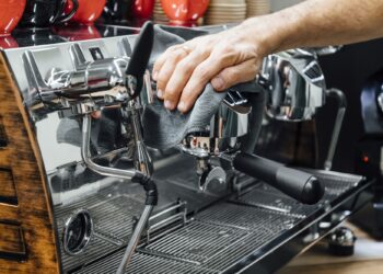 Barista cleaning the coffee maker
