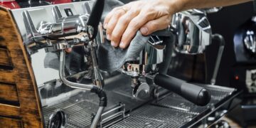 Barista cleaning the coffee maker