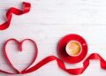 Valentines background with red heart and coffee cup. Valentines Day greeting card. Coffee break