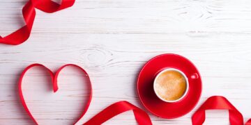 Valentines background with red heart and coffee cup. Valentines Day greeting card. Coffee break