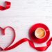 Valentines background with red heart and coffee cup. Valentines Day greeting card. Coffee break