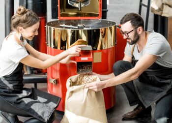 Pouring roasted coffee beans from the machine