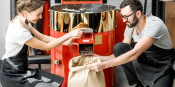 Pouring roasted coffee beans from the machine