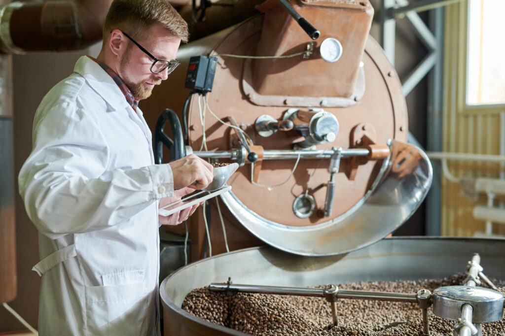 Worker Roasting Coffee at Factory