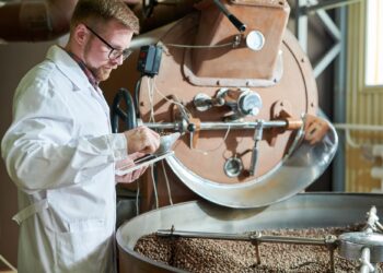 Worker Roasting Coffee at Factory