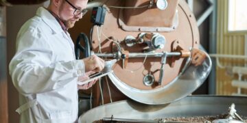 Worker Roasting Coffee at Factory